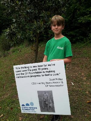 Ian standing by Livi's sign